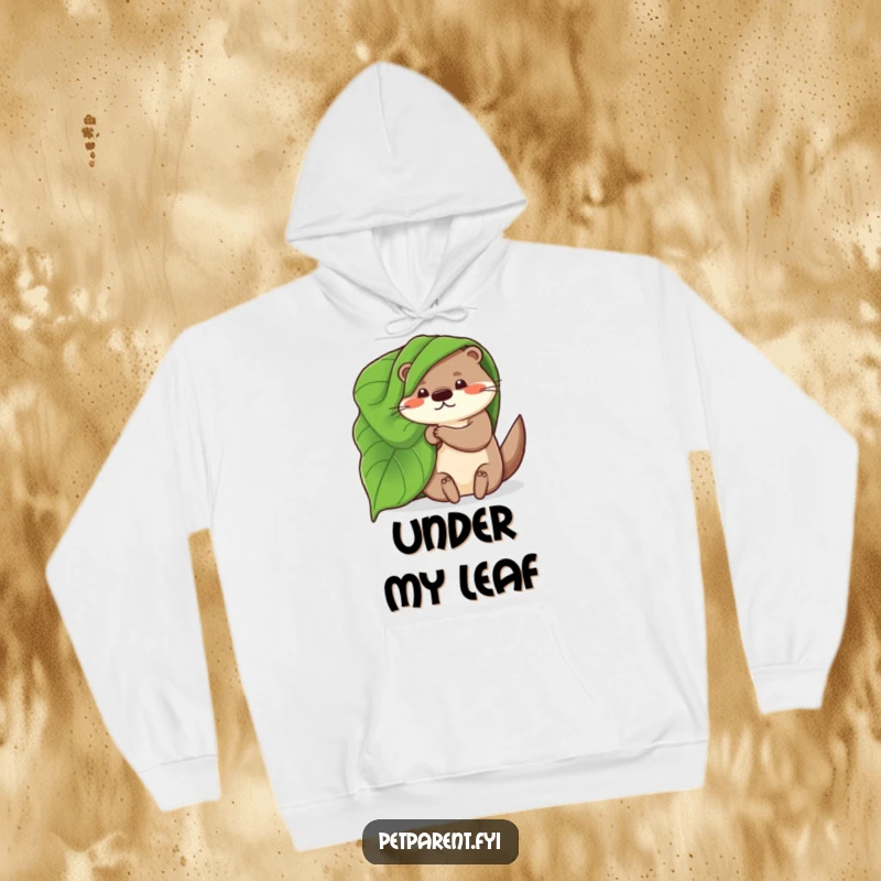 Funny, warm hoodie depicting a whimsical otter using a big leaf as a blanket, perfect for staying cozy with a smile.
