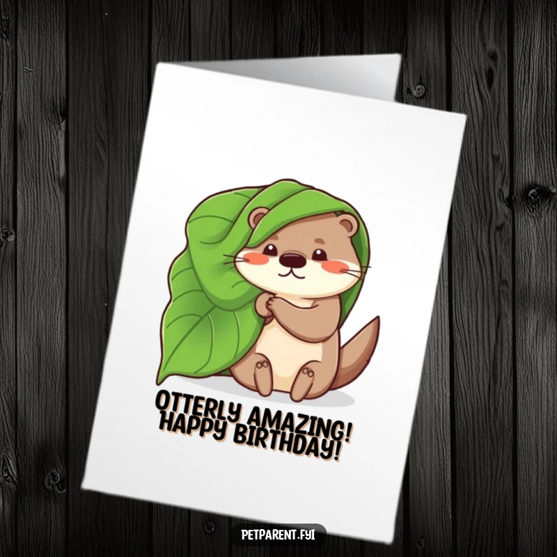 Free printable birthday card: A whimsical otter uses a large leaf as a cozy blanket, perfect for a snuggly wish.